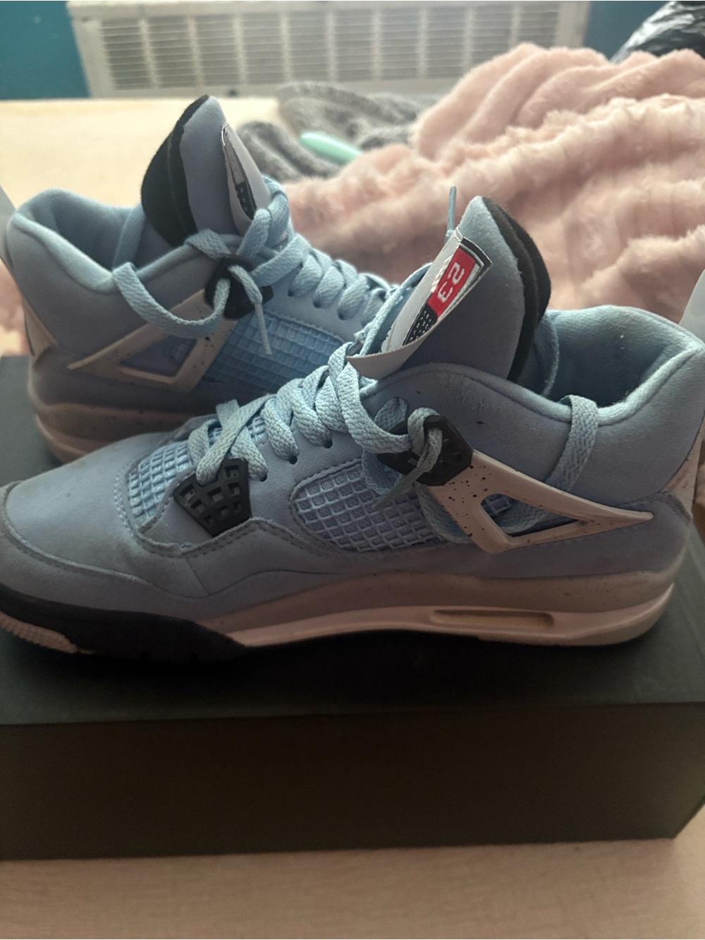 Jordan Retro 4 Sneakers in Light Blue and Black
